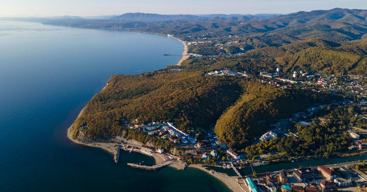 A breathtaking aerial view of Turbazy Primorskaya coastline showcasing lush hills and the expansive sea.