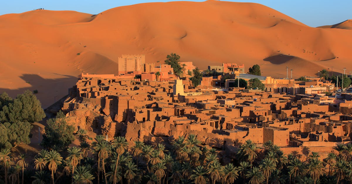 A stunning view of Taghit village and sand dunes in Algeria at sunset.