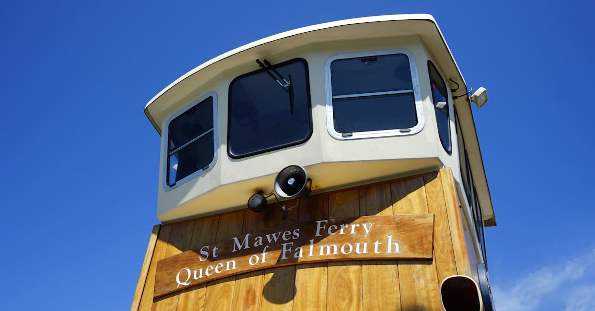 View of the St Mawes Ferry, Queen of Falmouth, against a clear blue sky.