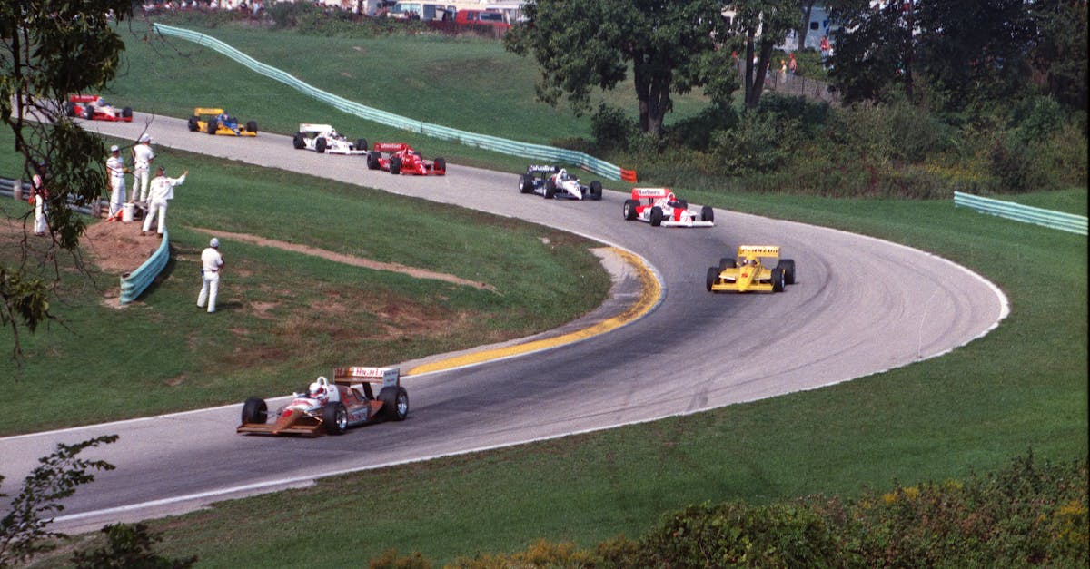 High-speed race cars on a curving track at Elkhart Lake, capturing motorsport excitement.