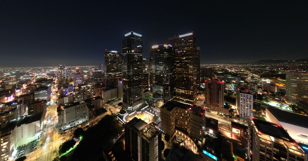 Experience the vibrant cityscape of Los Angeles with its illuminated skyline captured at night.