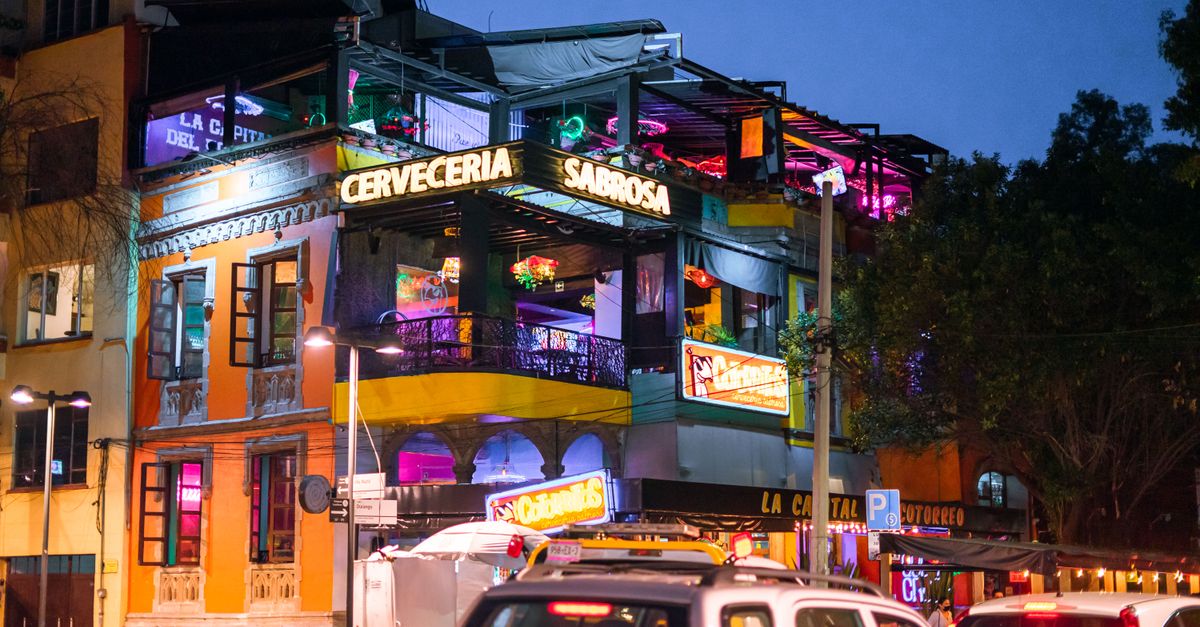 Colorful and lively bar scene at night in Ciudad de México's vibrant district.