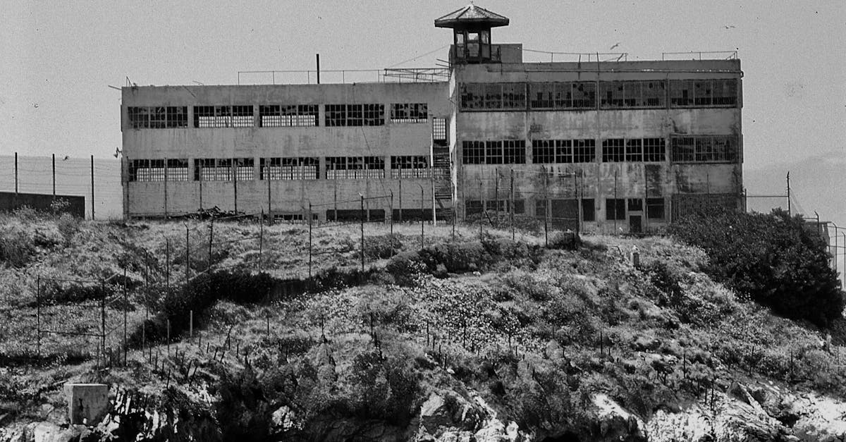 Black and white photo of an abandoned building on Alcatraz Island showcasing historical decay.