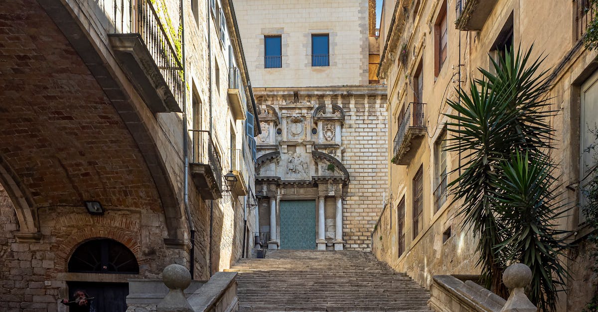 Charming stone staircase leading to the Church of Sant Martí Sacosta in Girona, Spain.