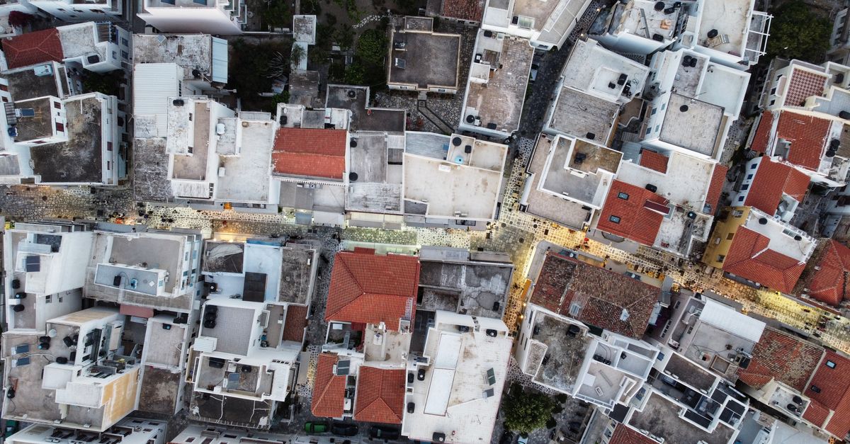 Top view of Tinos, Greece showcasing the urban architecture and street layout from above.