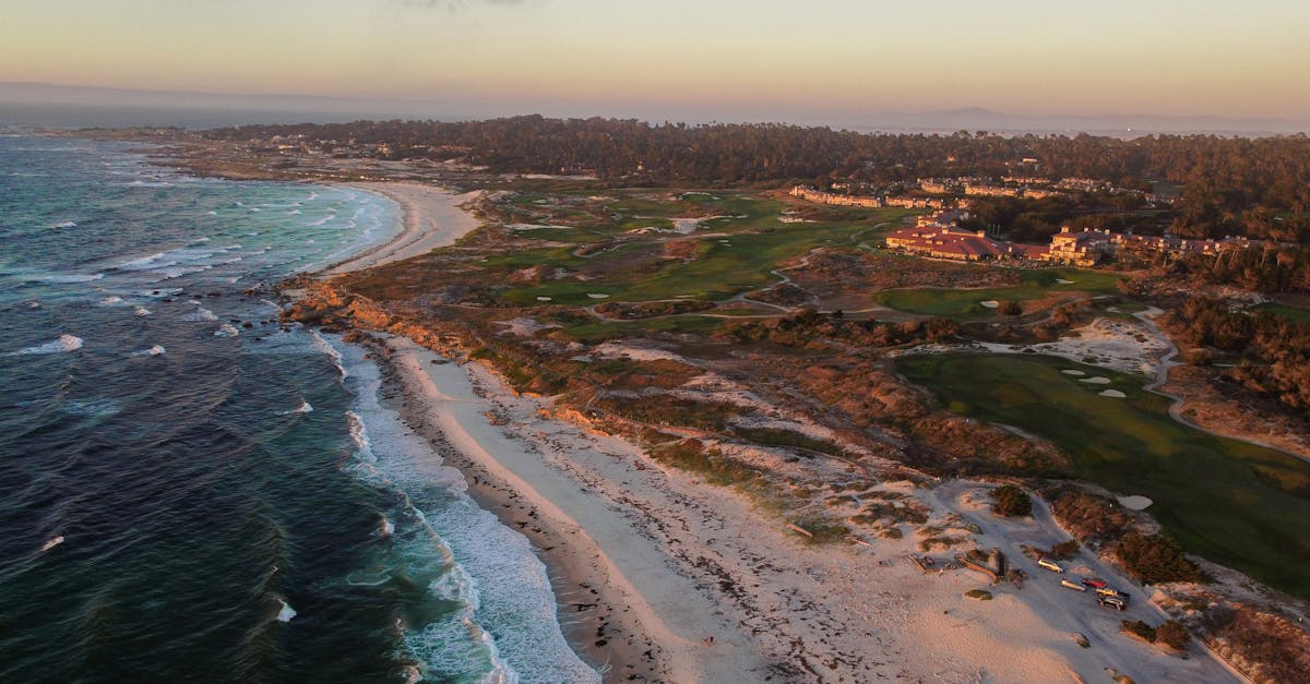 Stunning aerial view of Monterey's picturesque coastline at sunset, featuring waves and sandy beaches.