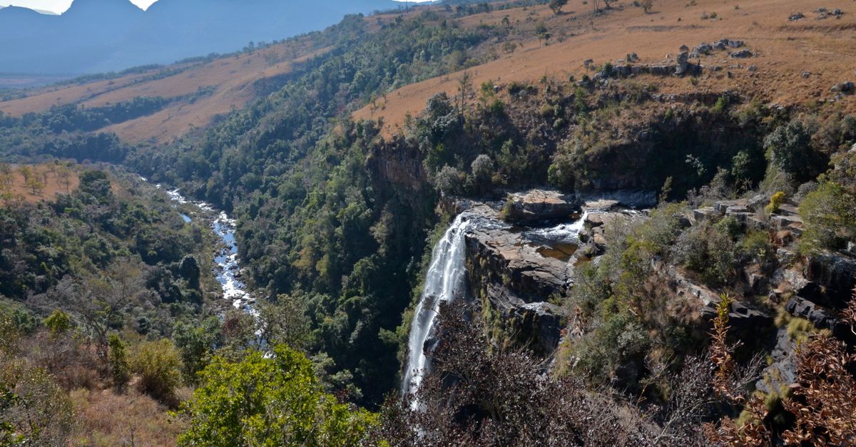 Breathtaking aerial view of a waterfall cascading through the lush landscapes of South Africa.