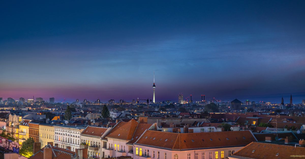 Panoramic view of Berlin skyline featuring the iconic TV Tower during twilight.