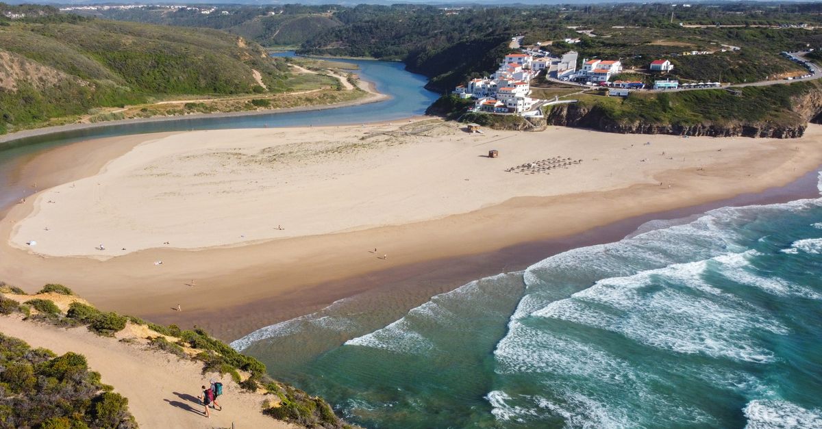 A breathtaking aerial shot of Praia de Odeceixe with its picturesque coastline and vibrant village.