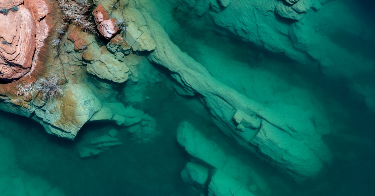 Top view of a rocky shoreline with clear turquoise water in Hurricane, Utah.