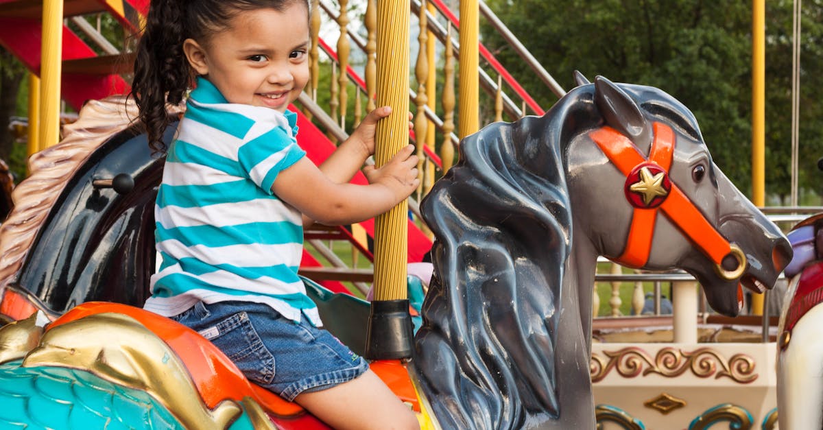 Joyful child enjoying a carousel ride in a vibrant amusement park setting.