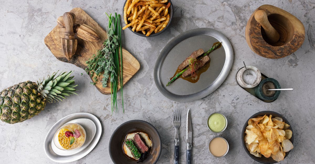 A top view of assorted dishes and ingredients on a gray stone surface.