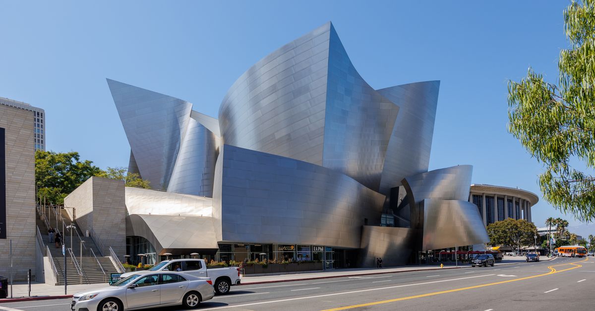 Modern architecture of the Walt Disney Concert Hall in Los Angeles under clear blue sky.