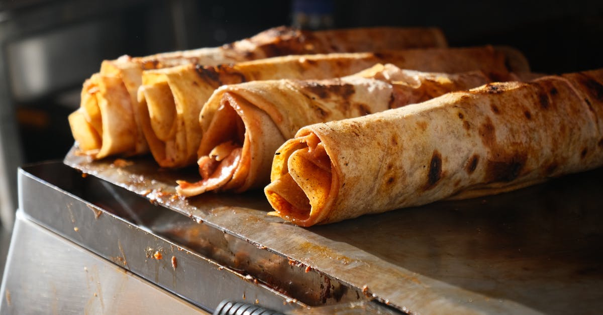 Close-up of traditional Turkish Dürüm wraps being grilled, showcasing delicious street food.