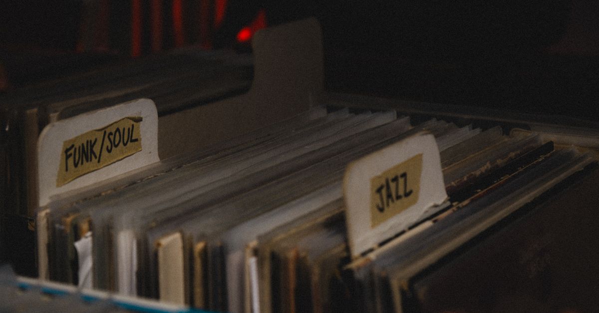 Collection of funk, soul, and jazz vinyl records sorted in a dimly lit environment.