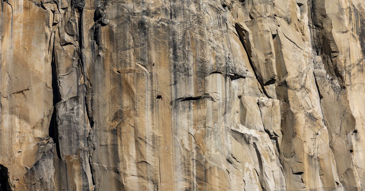 Rock climber on the iconic El Capitan in Yosemite National Park, showcasing the grandeur of vertical rock faces.