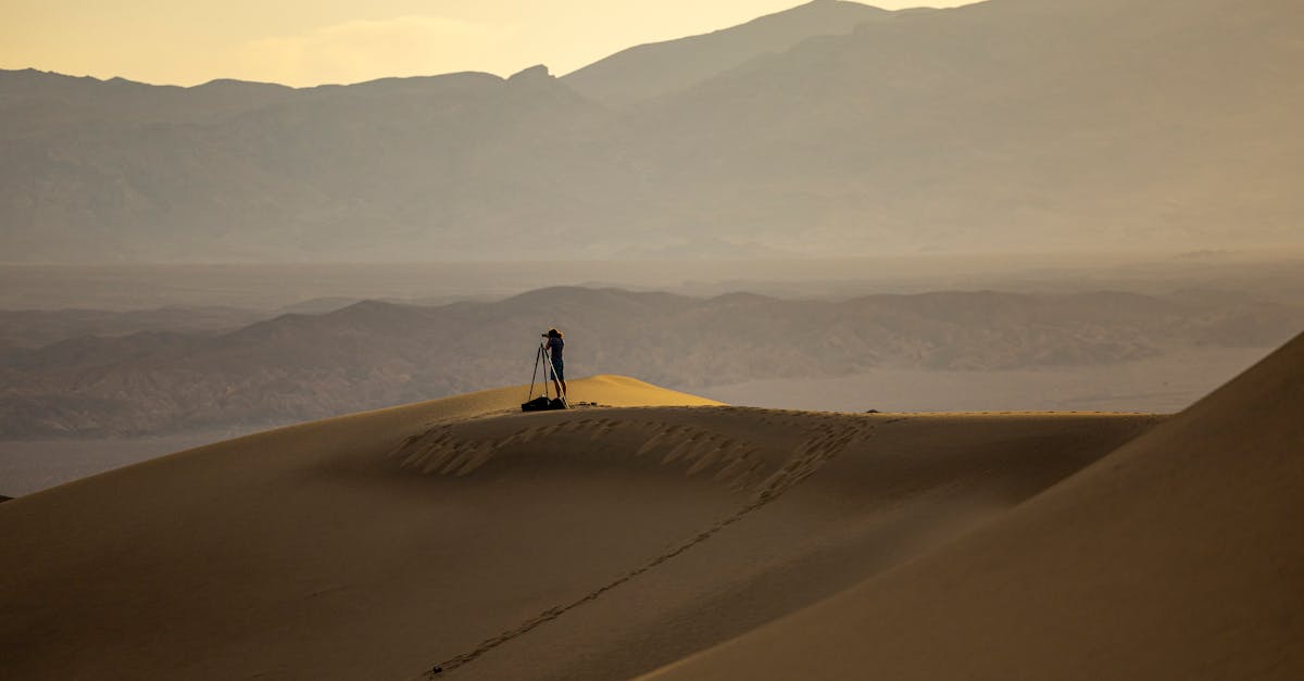 Photographer captures vast desert landscape during sunset, showcasing solitude and natural beauty.