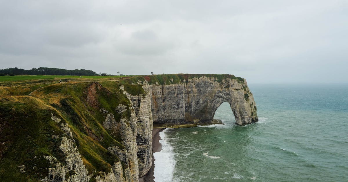 Stunning view of the iconic Etretat cliffs in Normandy, France with rough sea below.