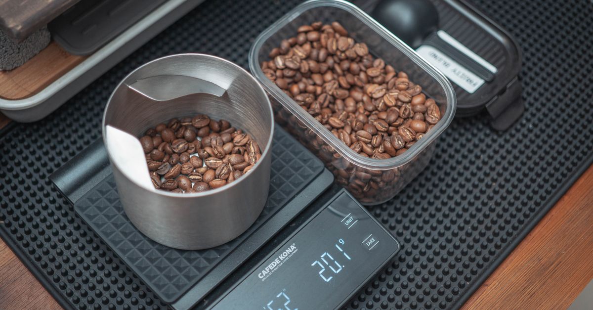 Close-up of coffee beans on a digital kitchen scale, perfect for precision brewing.