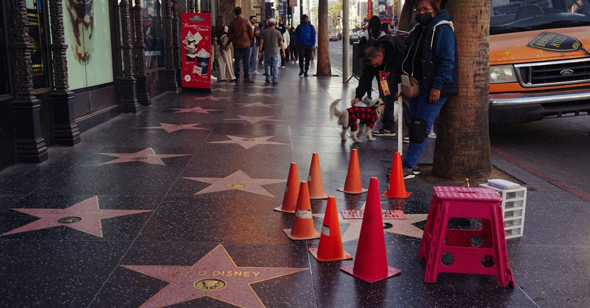 Vibrant day on the Hollywood Walk of Fame with stars and pedestrians.