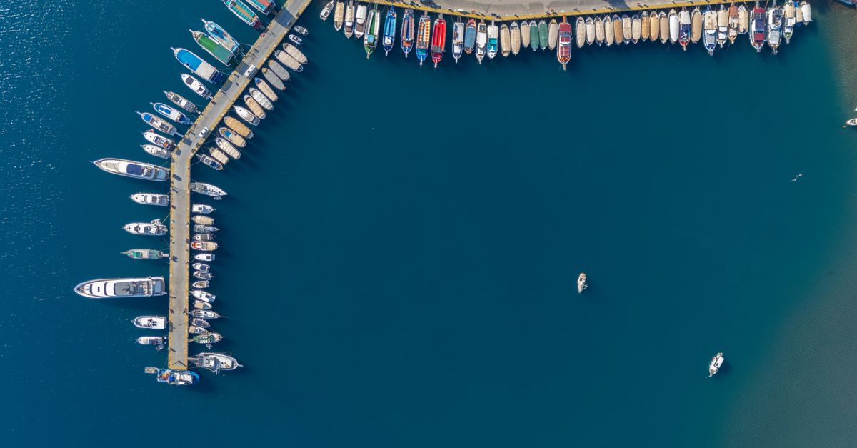 Stunning aerial shot of boats docked at Marmaris Marina in Türkiye, showcasing vibrant colors and serene waters.