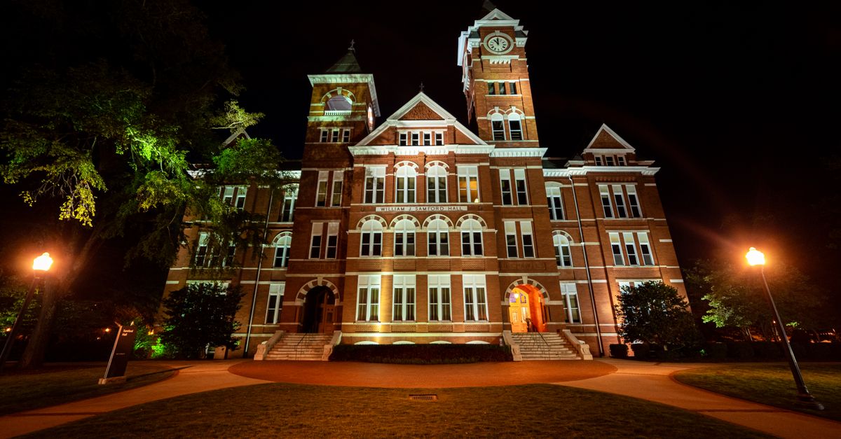 Illuminated view of Samford Hall, Auburn University at night, capturing the historic architecture beautifully.