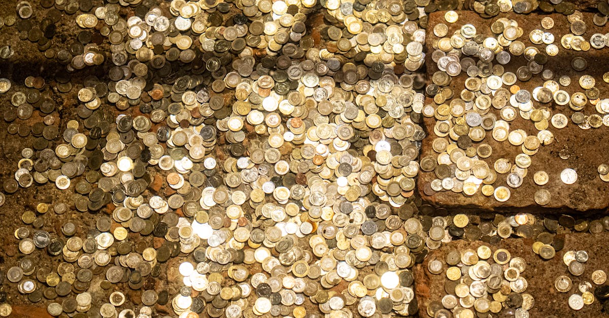 Scattered coins reflecting light in the historic Basilica Cistern of Istanbul.