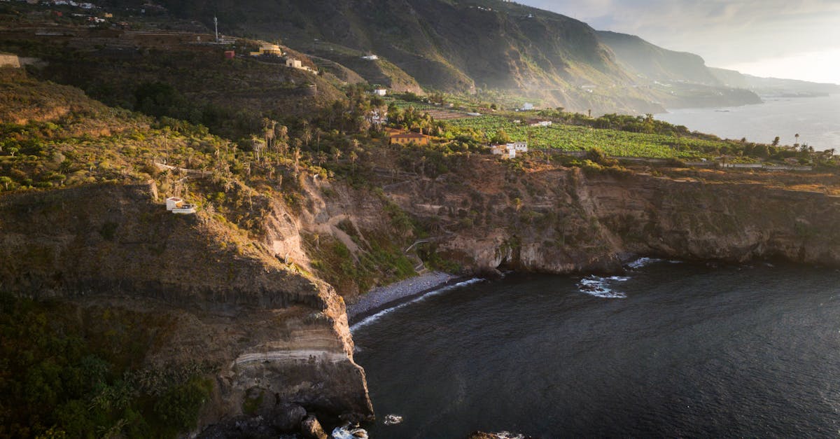 Beautiful aerial shot of the rugged coastline in the Canary Islands, showcasing dramatic cliffs and ocean views.