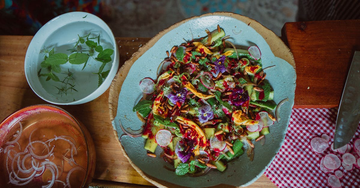 Vibrant summer salad featuring edible flowers, fresh vegetables, and herbs.