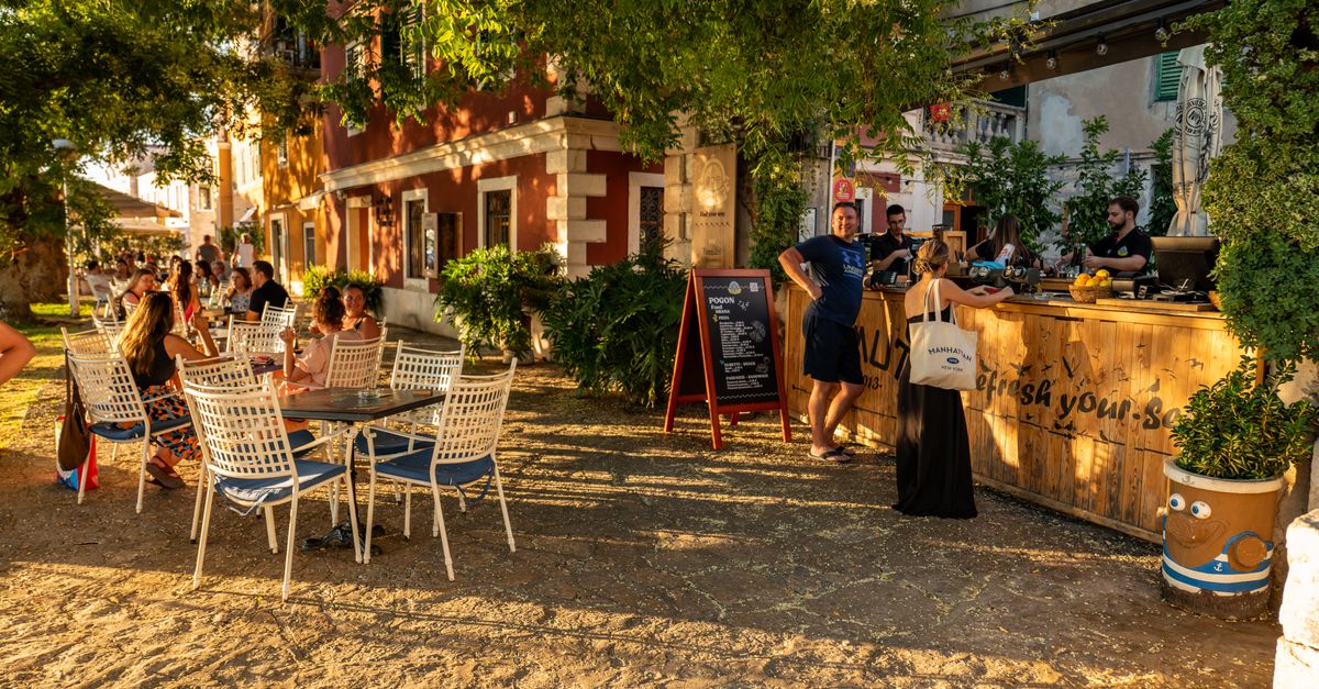 People enjoying a warm summer evening at an outdoor café in Šibenik, Croatia.