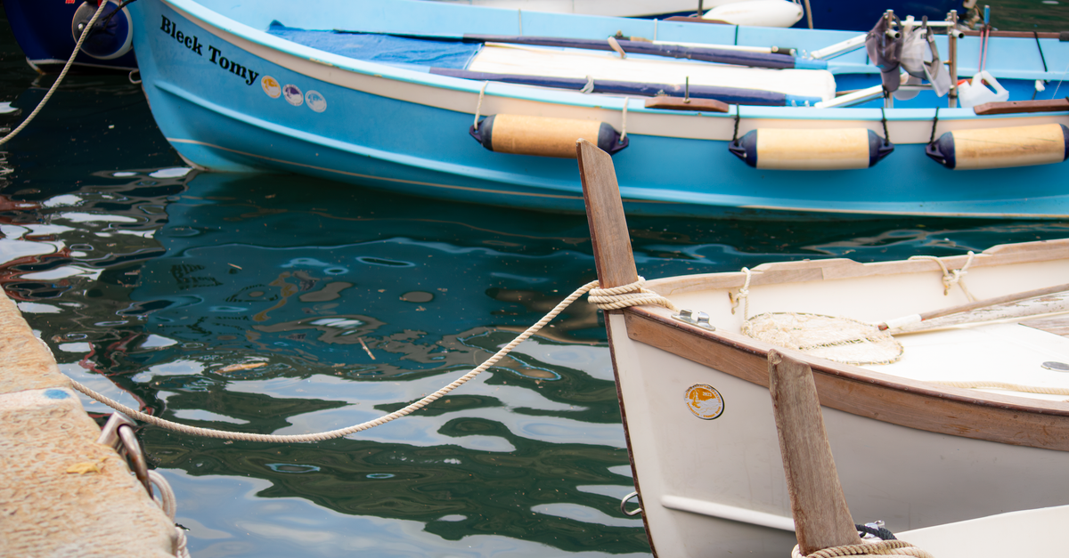Vibrant boats in the picturesque harbor of Vernazza, Liguria, Italy.