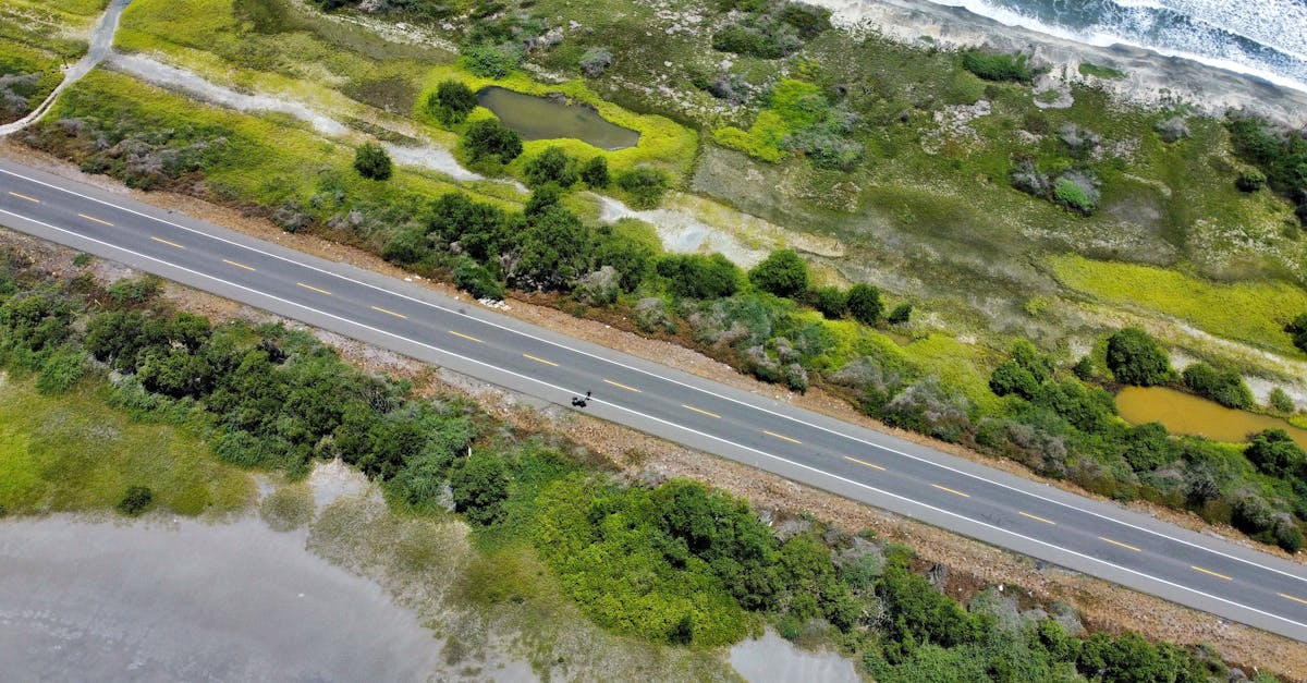 Aerial shot of lush coastline and road in Santa Marta, Colombia, showcasing natural beauty.