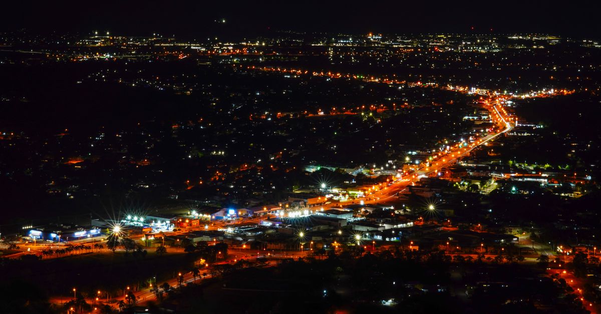 A stunning aerial view of a city's illuminated streets and lights at night.