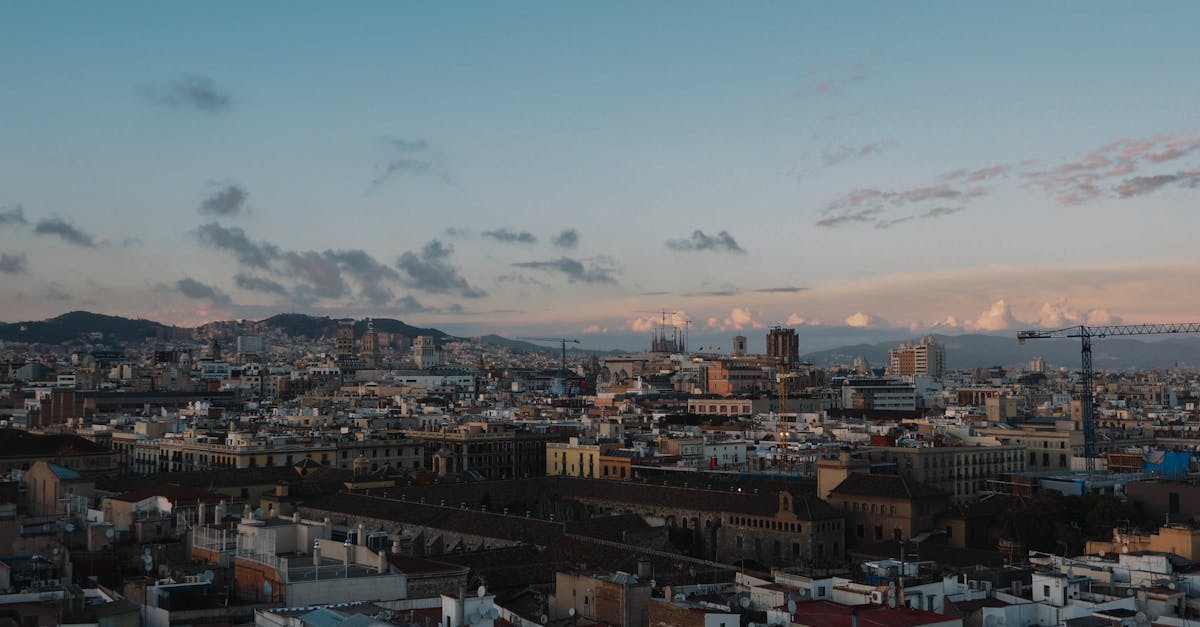 Stunning aerial view of Barcelona skyline during sunset, showcasing historic architecture.