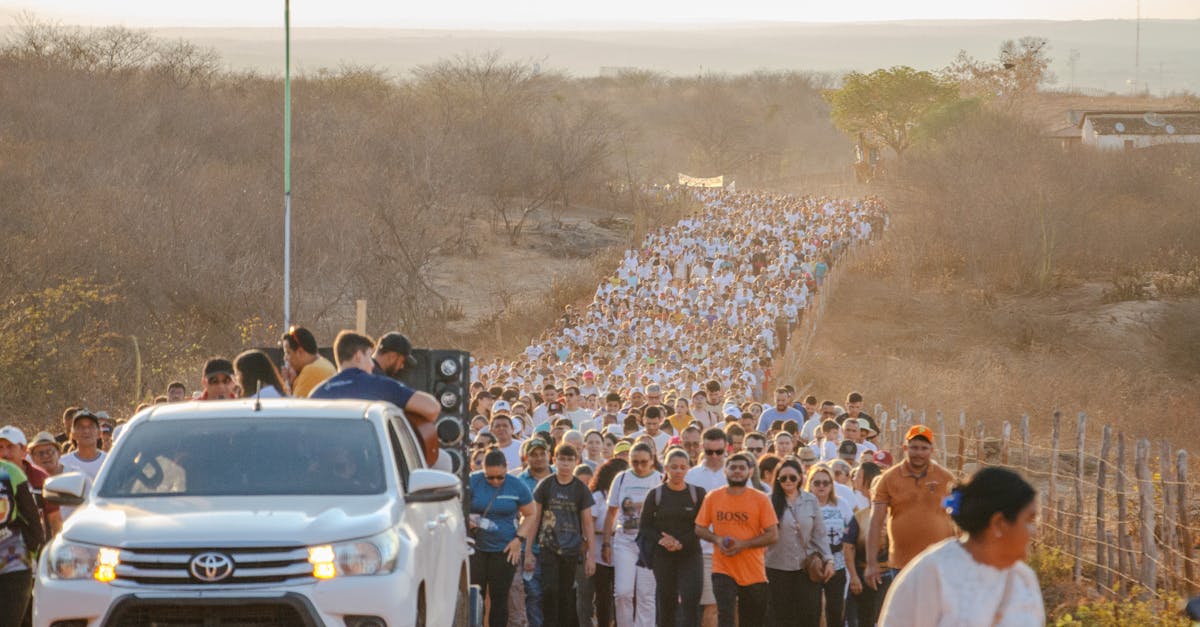 A large crowd participates in a pilgrimage through the arid landscape of Senador Pompeu, Ceará, Brazil.