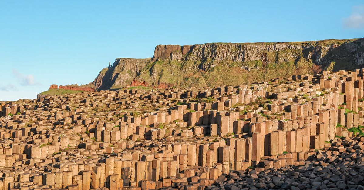 Stunning view of Giant's Causeway with hexagonal basalt columns and cliffs.