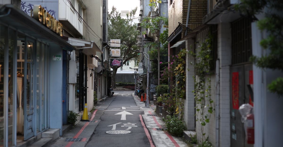 Explore a serene alleyway in Taipei, Taiwan, showcasing vibrant urban architecture and greenery.
