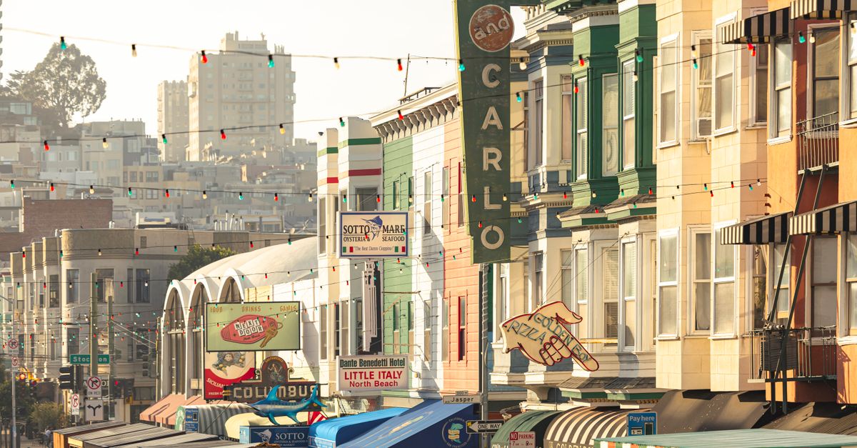 Colorful street view of North Beach, San Francisco with lively shops and iconic architecture.