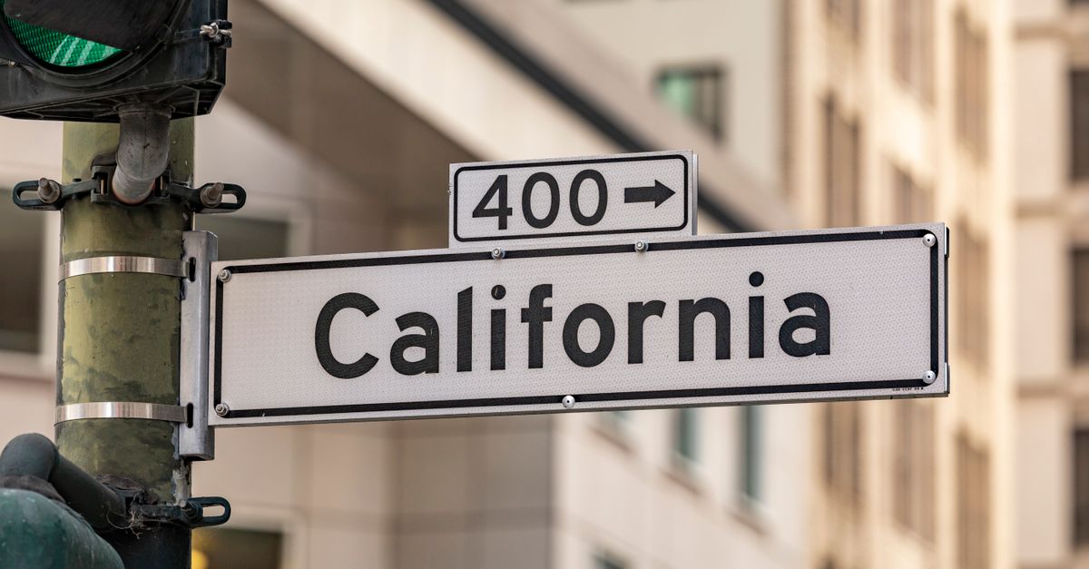 Street sign for California with traffic light in cityscape. Urban navigation and signage theme.