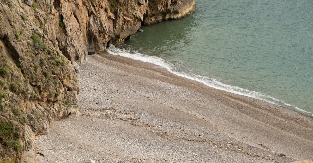 Stunning view of a secluded rocky beach with turquoise waters in Hatay, Türkiye.