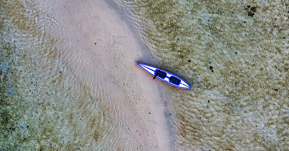 Aerial view of a solitary kayak in the crystal-clear waters of Indonesia's coastline.