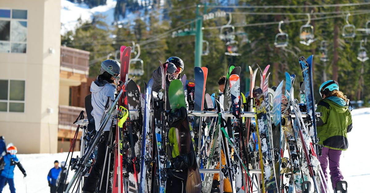 A lively scene of people gathering around ski gear at a snowy ski resort.