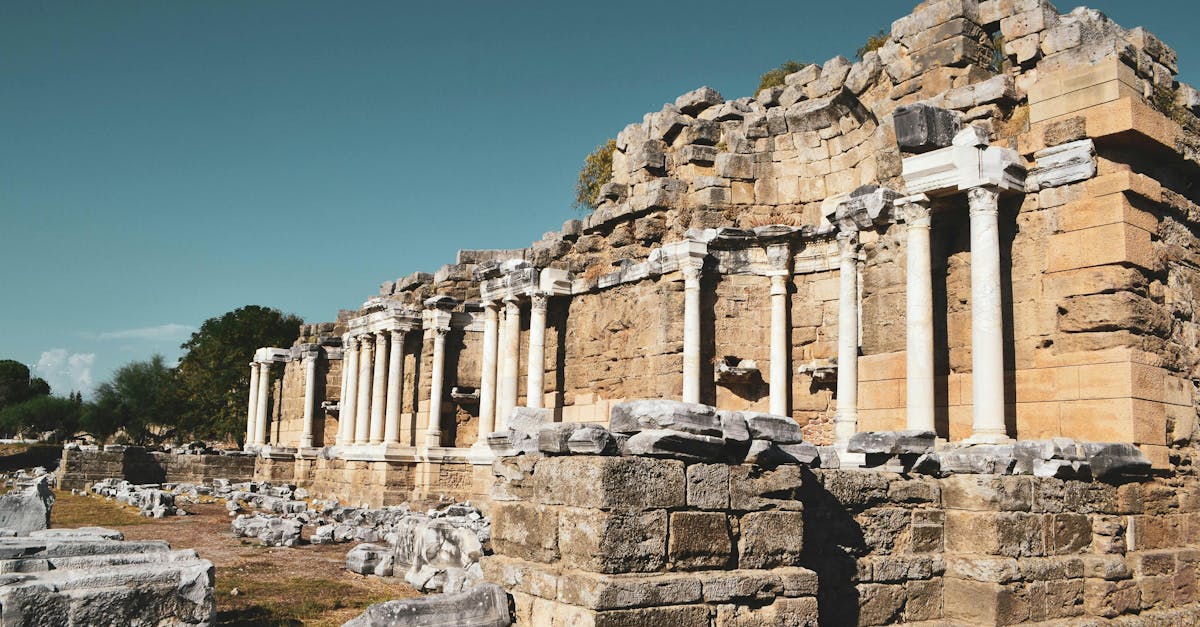 Explore the majestic ruins of ancient Roman architecture with standing columns under a clear sky.