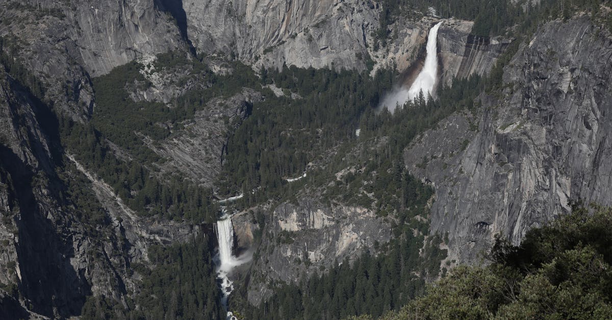 Stunning aerial view of waterfalls in Yosemite National Park's rugged landscape.