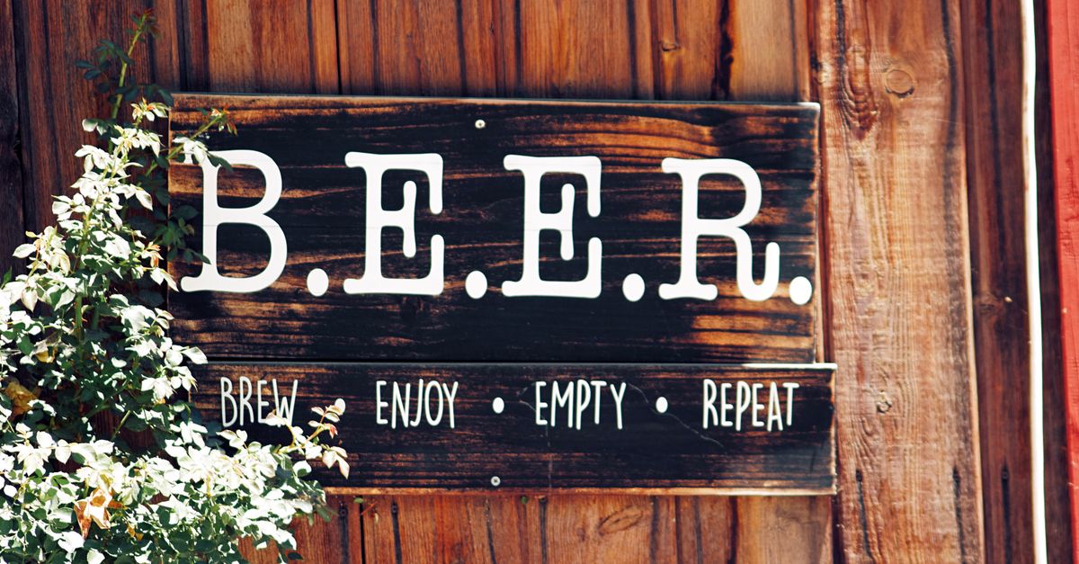 Rustic wooden sign with B.E.E.R. stands for Brew, Enjoy, Empty, Repeat.