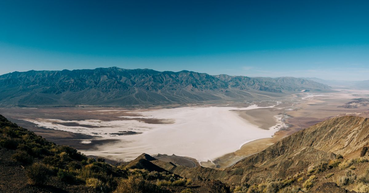 A breathtaking panoramic view of Death Valley lush with vibrant desert landscapes and rugged mountains.