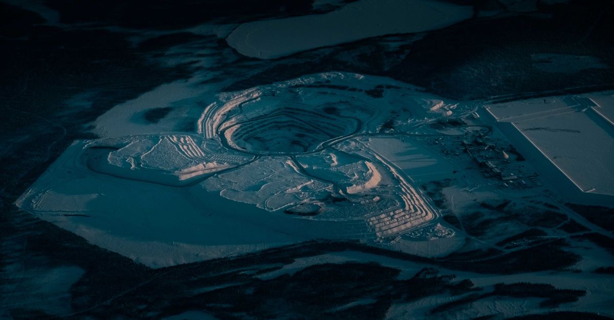 From above of sand pit with dry uneven surface and wavy traces in twilight