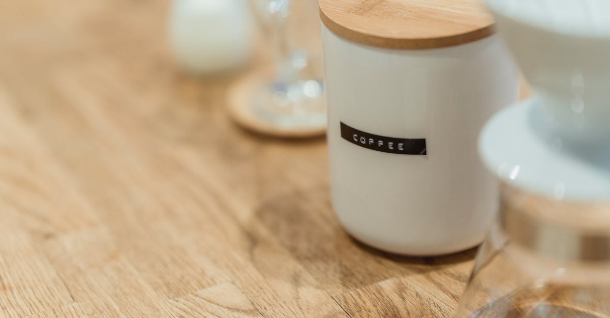 Close-up of a ceramic coffee jar with a wooden lid on a table, perfect for stylish kitchen storage.