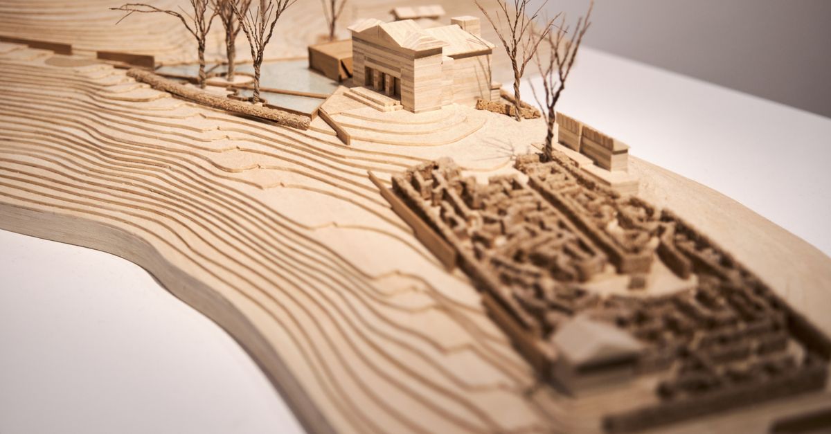 Intricate wooden architectural model showcasing design and topography in close-up view.