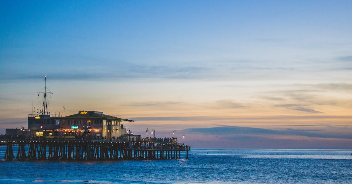 Serene twilight scene of Santa Monica Pier with ocean reflection at dusk.